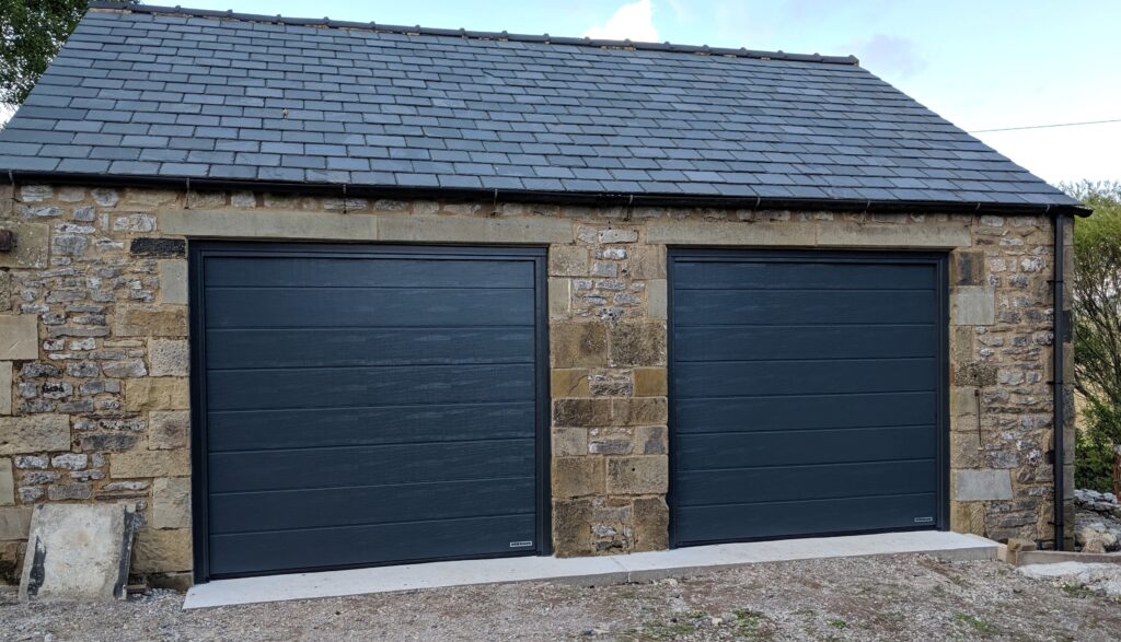 Pair of Black Insulated Garage Doors for a Brick Garage